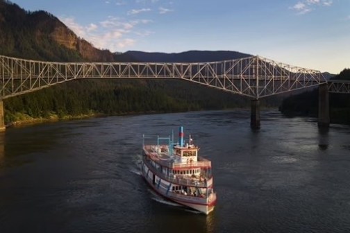 a train crossing a bridge over a body of water